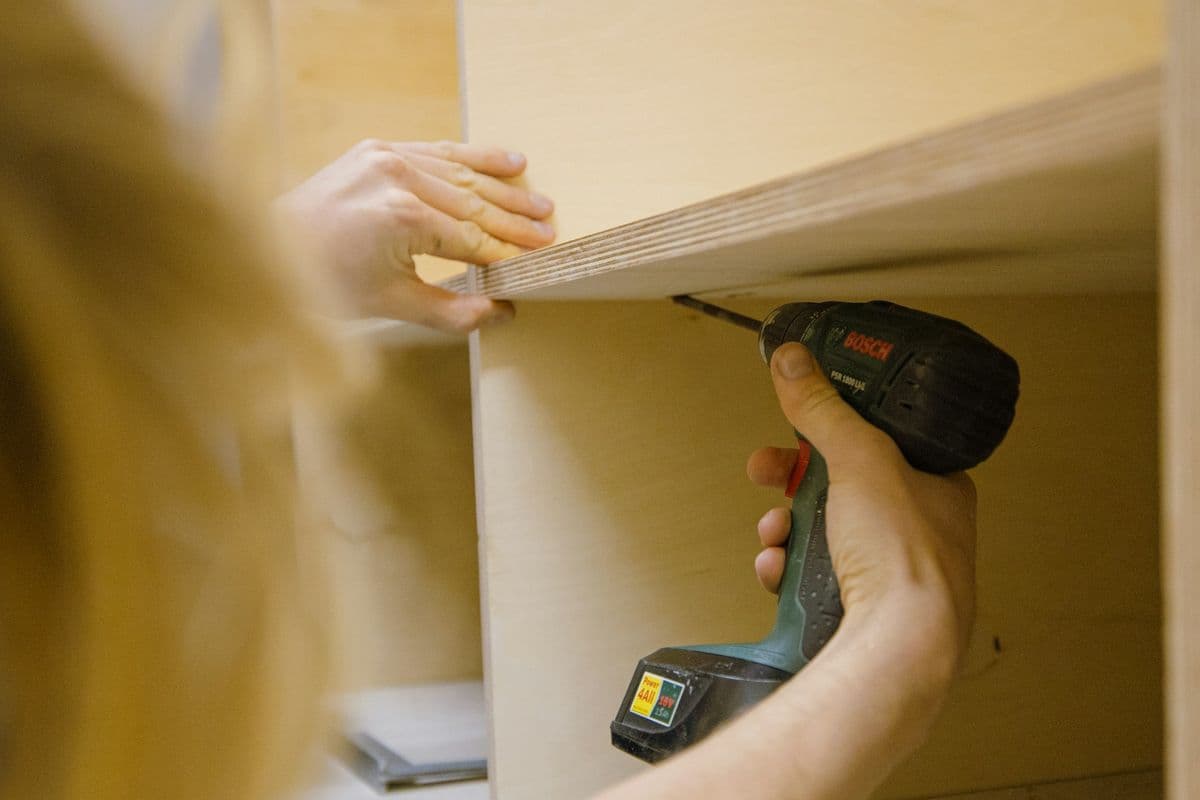 Assembling a wooden storage unit with a cordless drill
