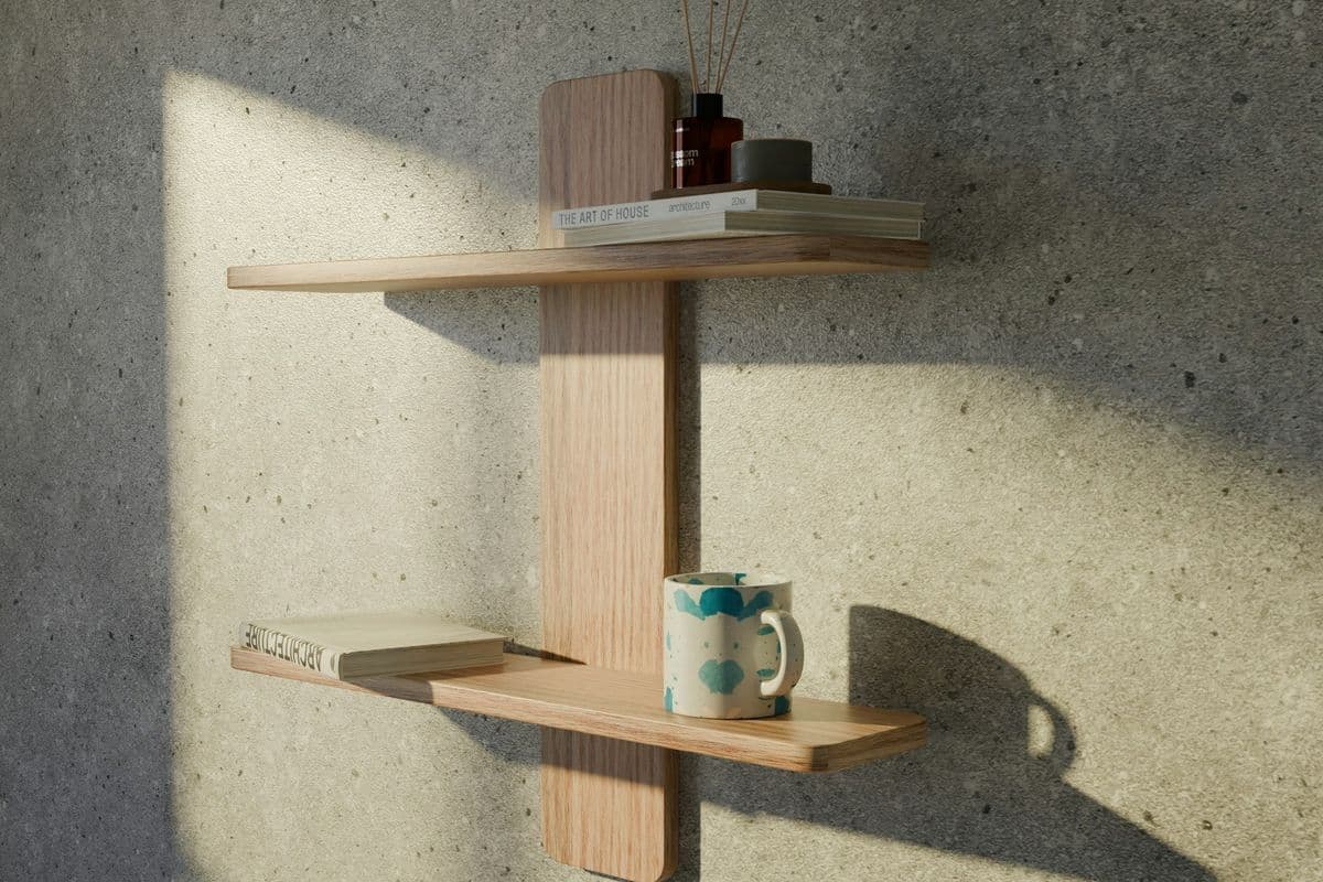 Wooden shelves fixed to a wall with books and a mug